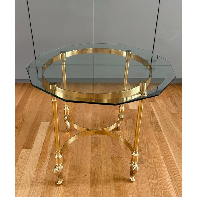 Vintage French style solid brass end table with a glass top in the style of LaBarge circa 1970s. It features octagonal...