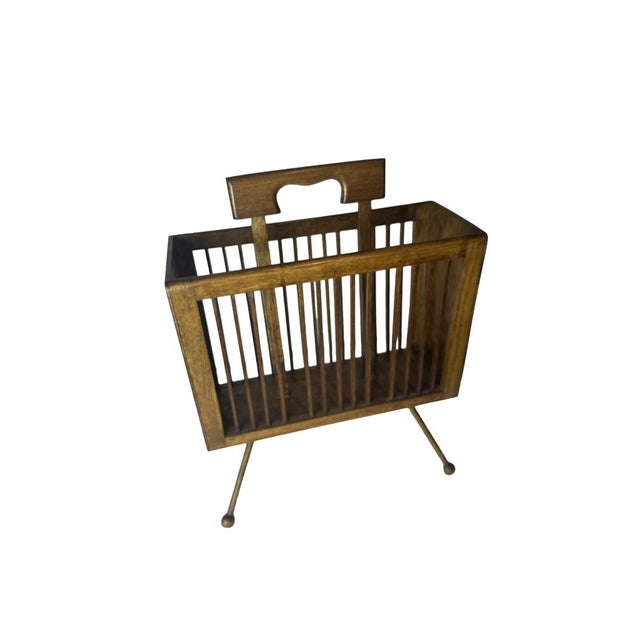 An elegant and beautifully proportioned magazine rack in white oak with a rich mahogany stain, raised on four slender...