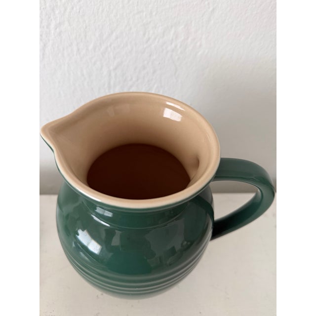 Vintage made in France, no longer in production, dark green and cream interior Le Creuset ironstone large pitcher.