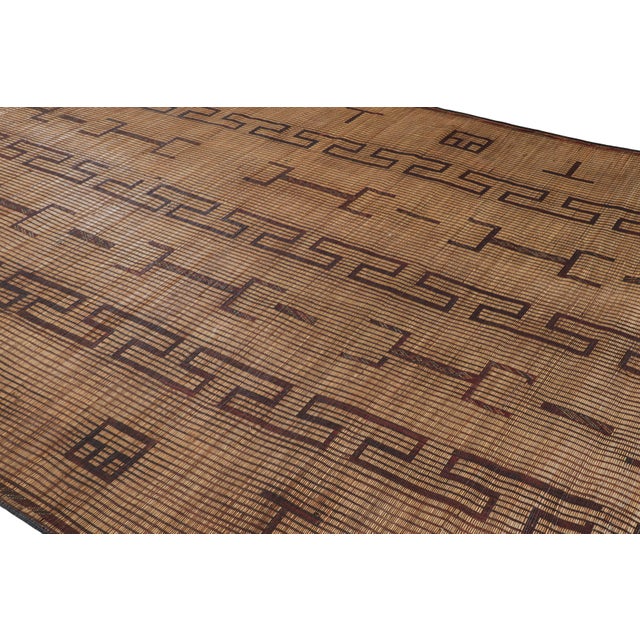 This vintage Moroccan floor covering is a 9×16 Tuareg mat from the nomadic tribe of the same name. Handwoven with reeds...