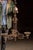Ornate cast iron chandelier featuring a three-arm configuration with elaborate Gothic Revival detailing throughout. The...