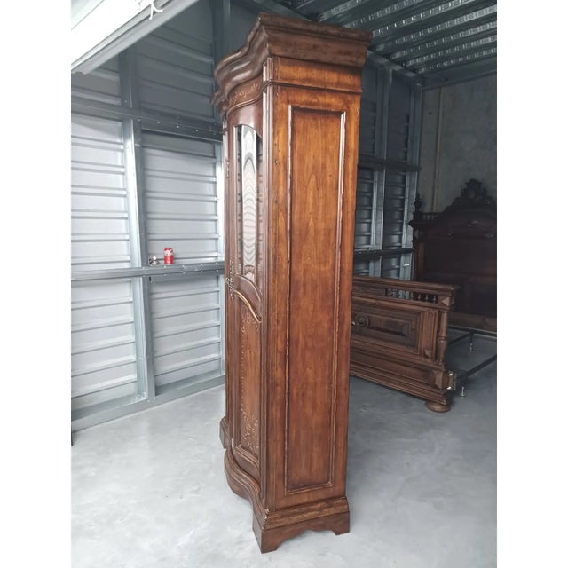 Vintage wine/bar cabinet, the upper section having a mirrored back, wooden slides for wine glasses, two wooden frames for...