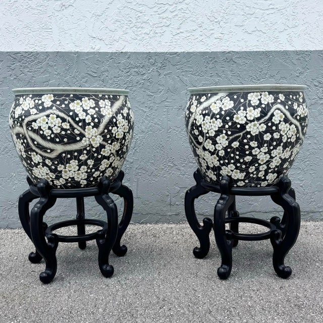 A beautifully executed pair of vintage Chinese hand-painted floor vases, traditionally used as fish bowls, resting on...