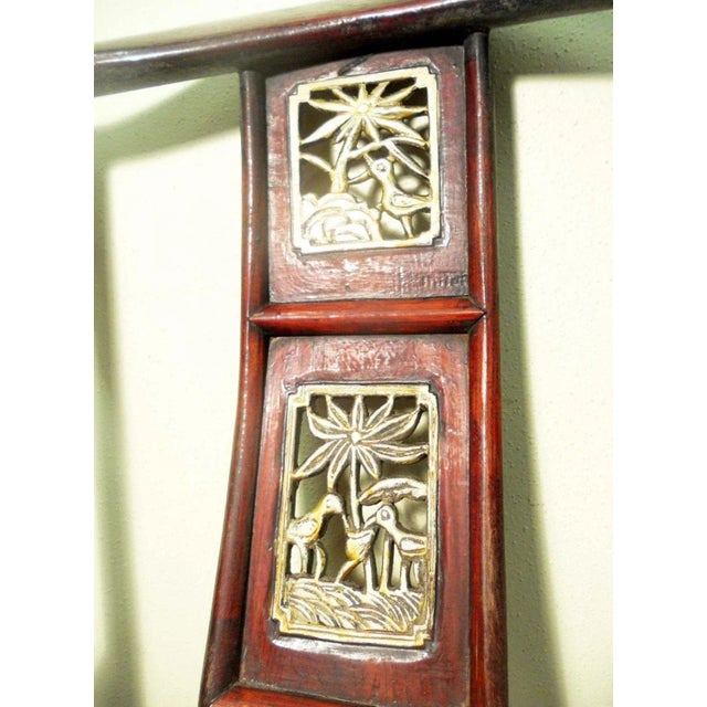 This style of chair is known as "official's hat chair" because the projections over the rear stiles resemble the knobs on...