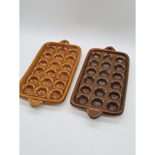 An original set of two large, heavy ceramic baking dishes, featuring a distinctive vintage style. Each pan features 18...