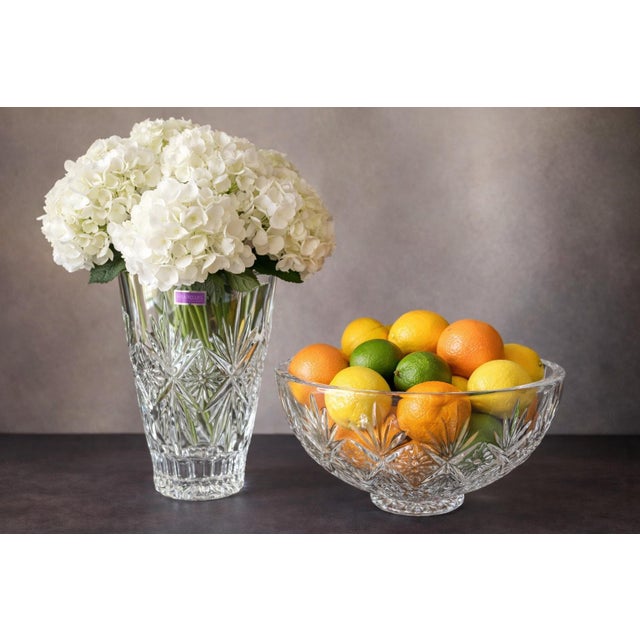 A beautifully coordinated Marquis by Waterford “Raymond” crystal vase and bowl set, showcasing intricate starburst cuts...
