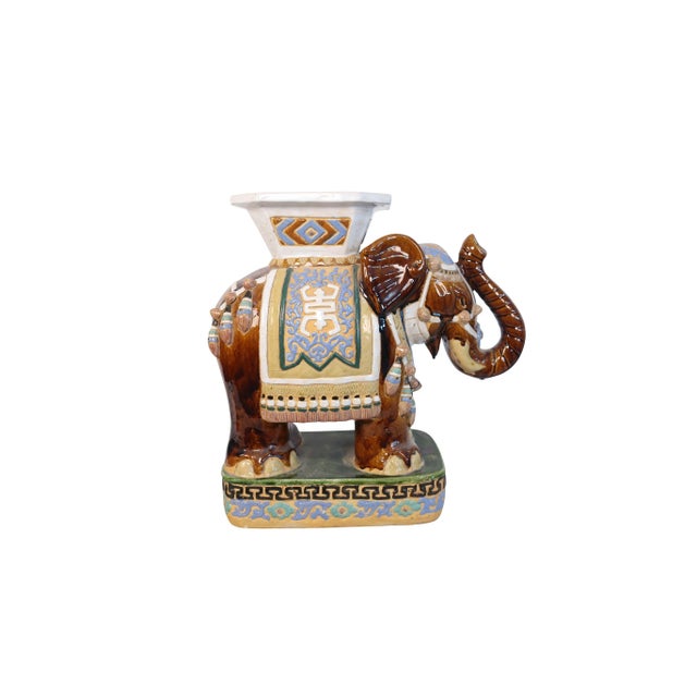 Single ceramic brown Asian elephant garden stool with brown yellow and white color and gold, green, and light lilac...
