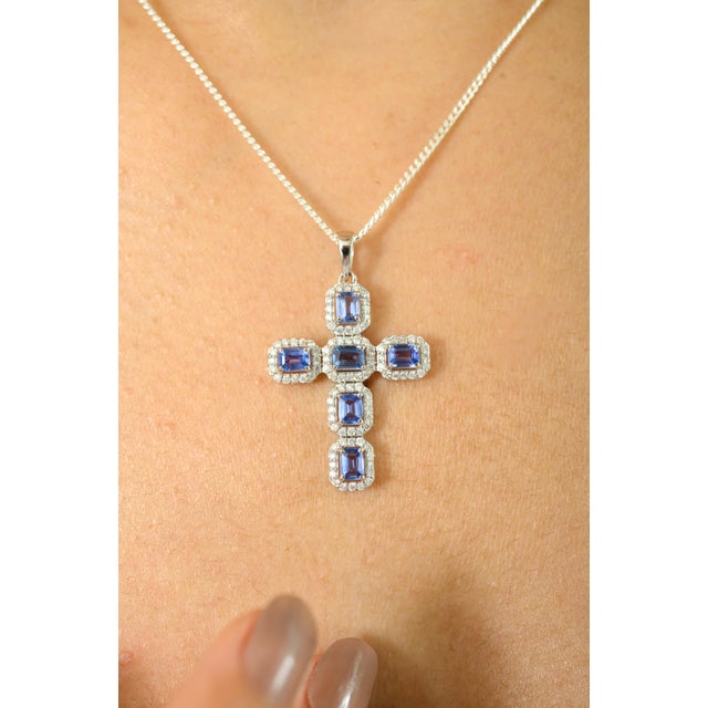 Exude grace and elegance with this stunning cross pendant, expertly crafted in 14K white gold. Featuring a total of 1.43...