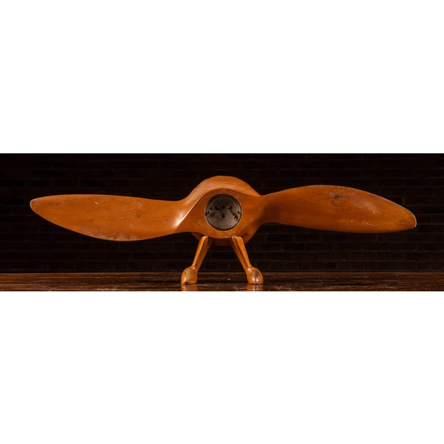 c. 1930s-1940s; Howard Clock Corp. - Boston, MA Carved wooden mantel clock executed in the form of a stylized airplane...
