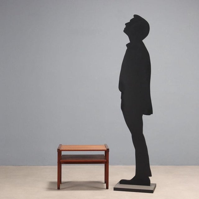 Coffee table with double top made of teak veneer wood. This piece is attributed to the mentioned designer/maker. It has no...