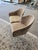 A pair of asymmetric accent chairs by Saporiti. Upholstered in a tan chenille with white legs.