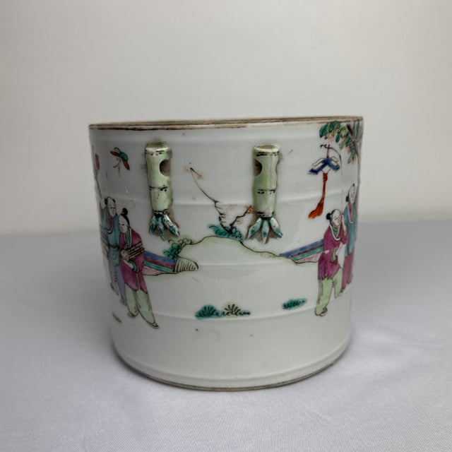 Stunning early 20th Century Famille Rose Cashepot. Garden scene with vibrant colors and bamboo handles. The cashepot is...