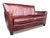 This vintage burgundy leather sofa features gently sloped arms, tailored lines, and piped detailing. Generously padded...