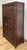Antique early 20th century Asian cabinet featuring intricately carved wood with classic oriental scenes. Top door pulls...