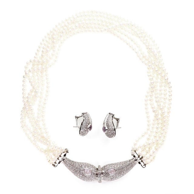 This is a gorgeus Estate earrings and necklace set. Crafted from 14k white gold, the necklace has 4 strands of 4.4mm...