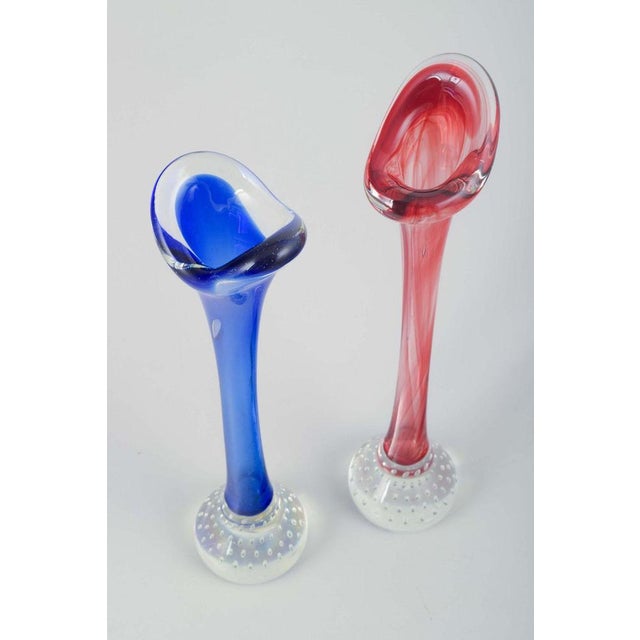 Swedish glass artist. Two vases in colored and clear glass. Organic forms with optical air bubbles in the base. A pair of...