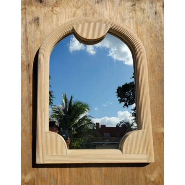 A fantastic vintage cerused pencil reed mirror featuring a beautifully sculptural arched frame with refined Postmodern...
