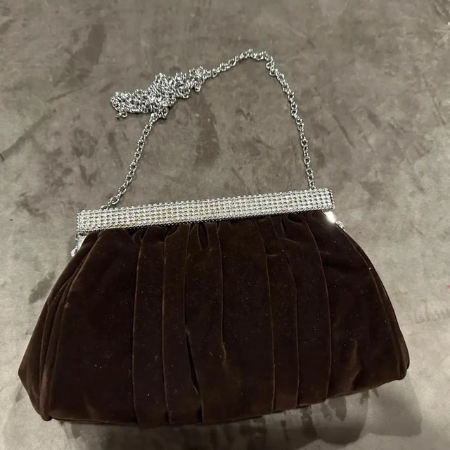 An exquisite vintage Italian evening bag from the 1980s. Crafted in Italy from a luxurious and soft brown suede, this...