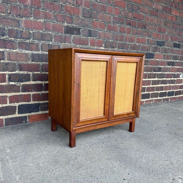 A beautifully crafted Mid-Century Modern cabinet from the highly collectible Wonderwood collection by American of...