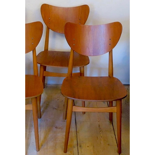 Set of 4 finely made 'butterfly' dining chairs, two-toned in teak and beech, with unusually shaped 'butterfly' backs and...