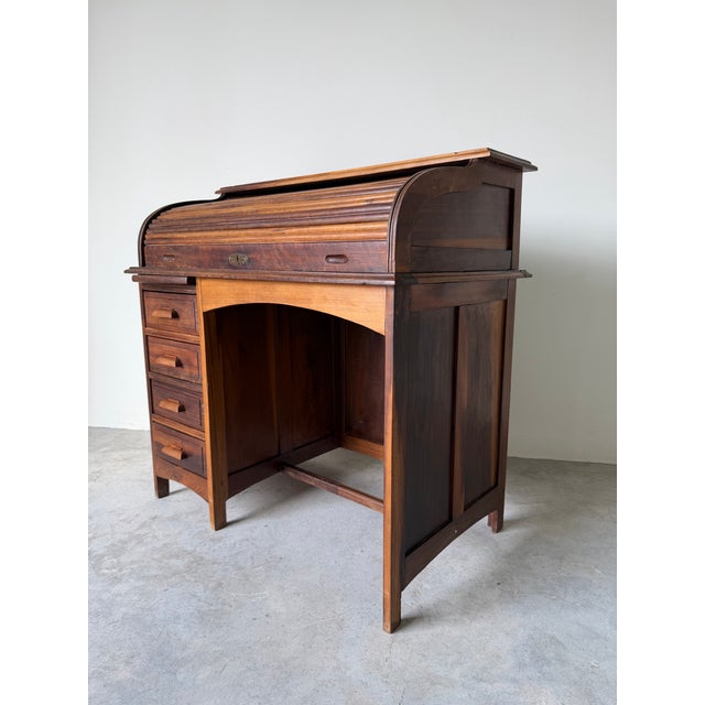 This antique solid wood roll top desk features the classic early 20th century design admired for both its practicality and...