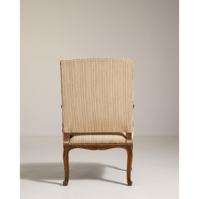 A stately Louis XVI style throne chair defined by its high back, straight lines, and neoclassical symmetry. Unlike the...