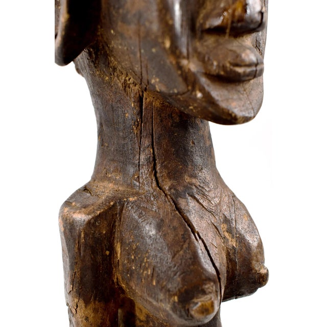 Figure stands on its own but is a bit wobbly. This carved figure comes from the Senufo people. The shape and detailing of...