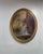 This oval vintage oil painting features a romantic Victorian parlor or ballroom scene with a couple in period attire,...