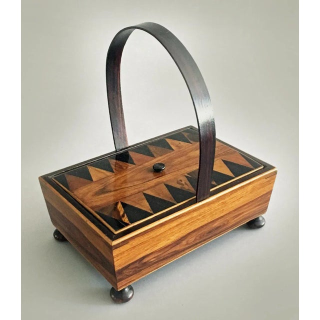 A rare early 19th century Tunbridgeware rosewood sewing box with hoop handle, the lid with tiny carved knob is decorated...