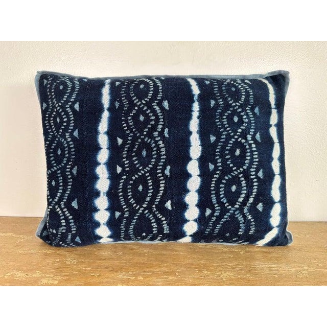 Decorative pillow crafted from an authentic indigo-dyed tribal textile, featuring rhythmic resist-dyed motifs and dotted...