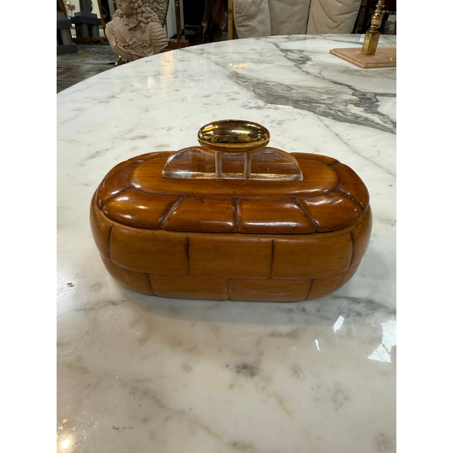 Beautiful vintage trinket box crafted from richly toned carved wood with an eye-catching segmented design reminiscent of...