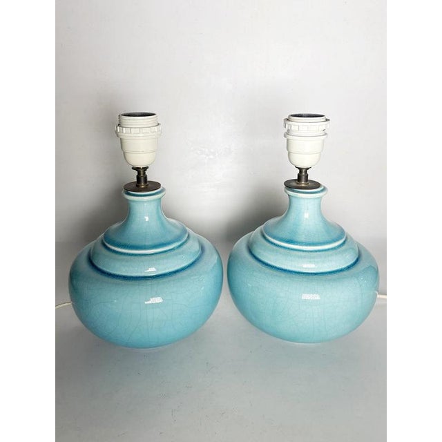 The lampshades are not included! Pair of French ceramic table lamps dating from the 1970s. Featuring elegant rounded...