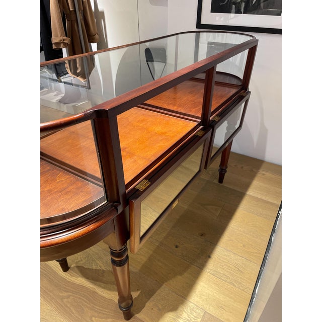 Gently used display case in an understated antique style with gorgeous bow end cabinet. The cabinet is constructed of...