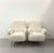 A stylish pair of vintage lounge chairs featuring softly sculpted forms newly upholstered in warm ivory bouclé. Rounded...