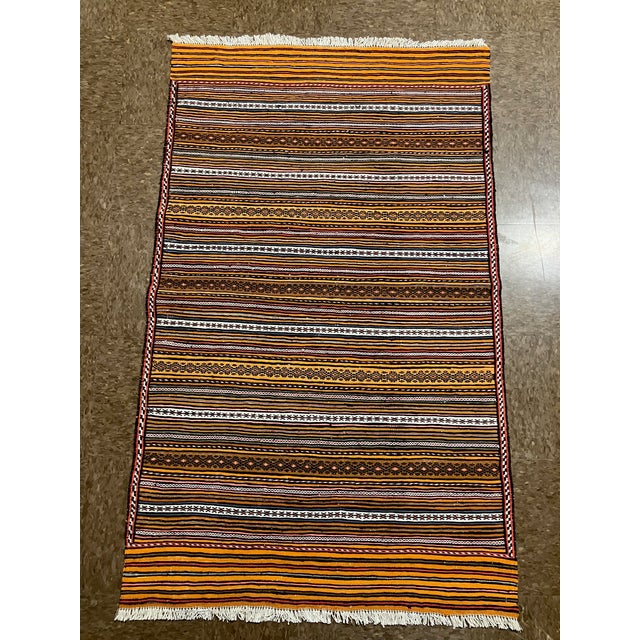 Vintage handwoven Afghan Meymana kilim flatweave rug featuring a striped field with alternating horizontal bands of fine...