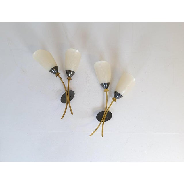 These wall mounted lamps were created in sweden during the 1950s attributed to asea belysning, wonderfully sculptured with...