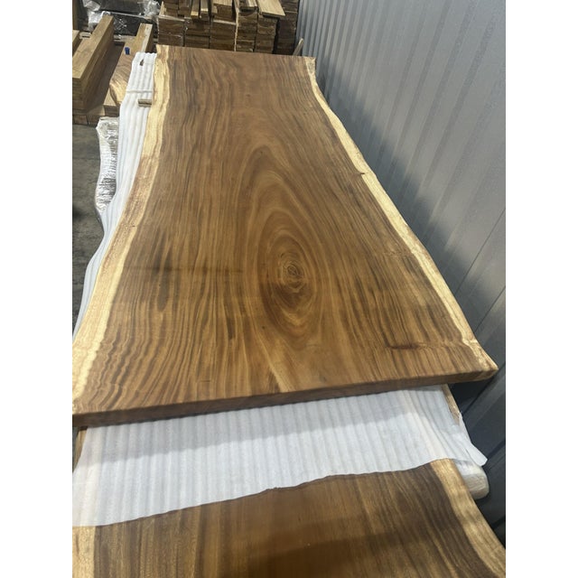 One tree. One top. One of one. A true single-slab live edge table: one continuous cross-section of a single Saman tree...