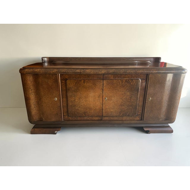 An exceptional Art Deco sideboard from the 1930s – crafted from exquisite walnut with a striking burl veneer that...