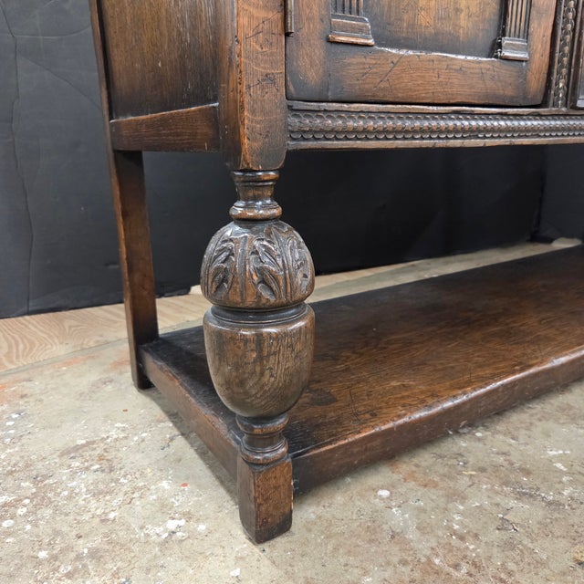 This English Oak Sideboard With Bulbous Front Legs and Potboard Base has great storage. It has 2 large drawers and 2 side...