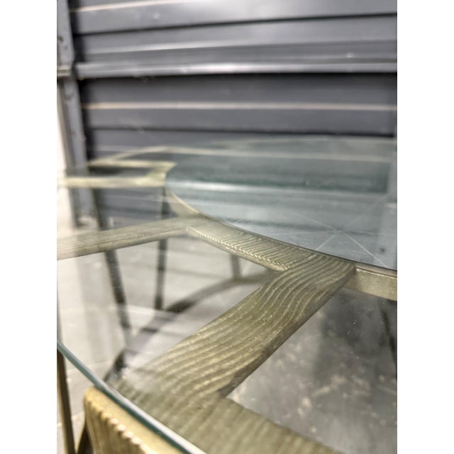 Gorgeous coffee table with eglomaise center . Silvered metal base with floating top.