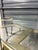 Gorgeous coffee table with eglomaise center . Silvered metal base with floating top.