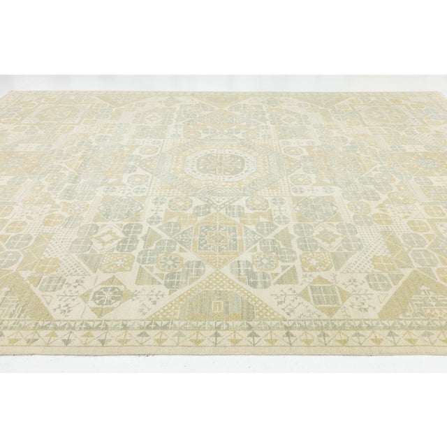 Elevate your space with this Modern Khotan style rug, showcasing an intricate design in sand, sage green, and soft gold....