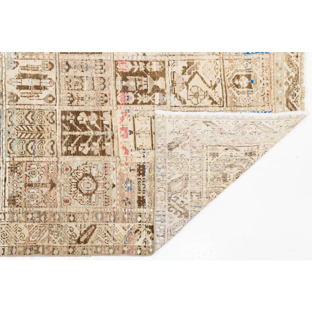 Crafted with exceptional artistry, this vintage wool rug features a classic Khesti (panel/garden) design composed of...