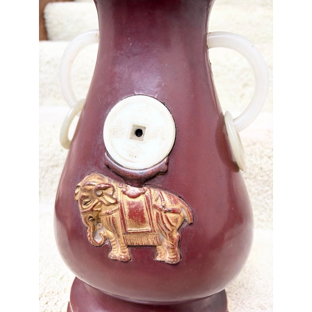 This is a rare Antique Chinese Wine Red Lacquer Wood Vase With Jade Ring Handles. Circa 1900, it’s in very good condition...