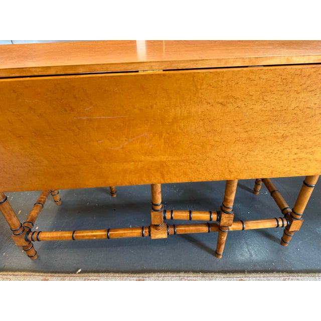 This is a Vintage Birds Eye Maple Drop Leaf Table. With the leaves down it has a depth of 16”. It has two drawers that...
