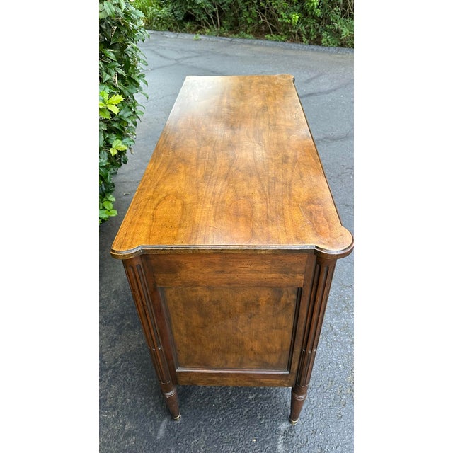 French Vintage Baker French Louis XVI Style Console Chest | Flamed Walnut 2-Drawer Commode With Bronze Mounts & Brass Sabots For Sale - Image 3 of 12