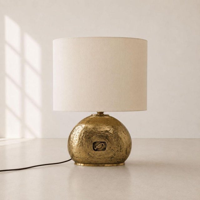 Large 1970s Italian table lamp crafted from solid cast brass, complete with an oval lampshade. The base features a...