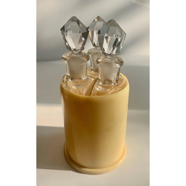 Set of three bottles in holder - three unique triangular shaped bottles with crystal stoppers in round holder. The trio...