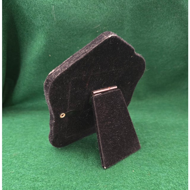 Solid Sterling Silver Edwardian-style frame with round window that features beautiful floral and swirling motifs in its...