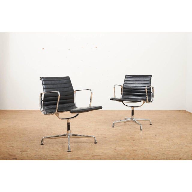 Swivel Chair EA 104 in Chrome-Plated Aluminum and Black Leather Upholstery by Ray and Charles Eames for Vitra, 1958, in...
